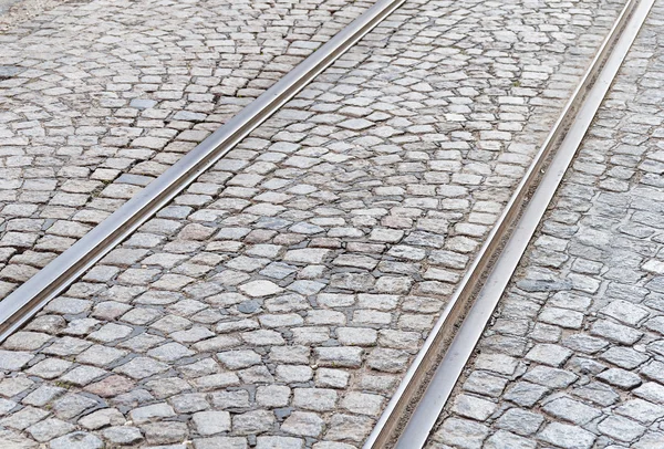 Old rail lines on cobbled road surface — Stock Photo, Image