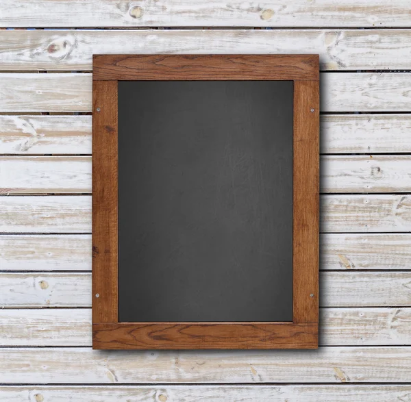 Blackboard in wooden frame on wooden wall — Stock Photo, Image