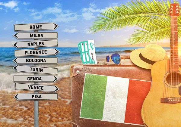 Concept of summer traveling with old suitcase and Italy town sign with burning sun — Stock Photo, Image