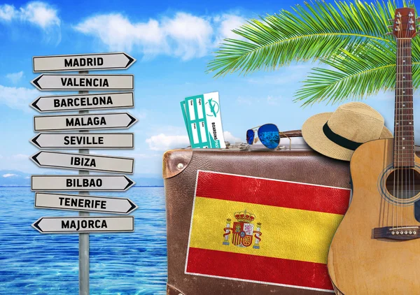 Concept of summer traveling with old suitcase and Spain town sign — Stock Photo, Image