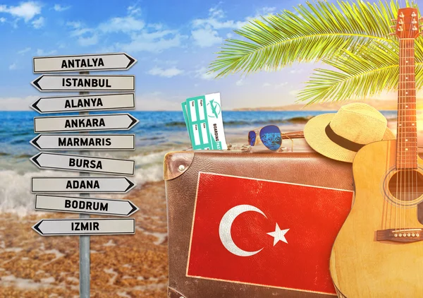 Концепция летнего путешествия со старым чемоданом и турецким городом с пылающим солнцем — стоковое фото