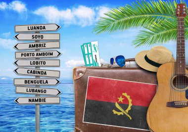 Concept of summer traveling with old suitcase and Angola town sign clipart