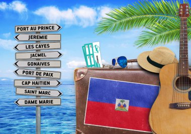 Eski bavul ve Haiti town işareti ile seyahat yaz kavramı