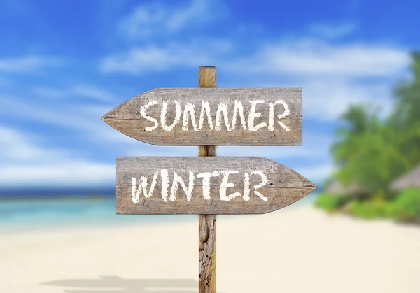 Wooden direction sign summer or winter — Stock Photo, Image