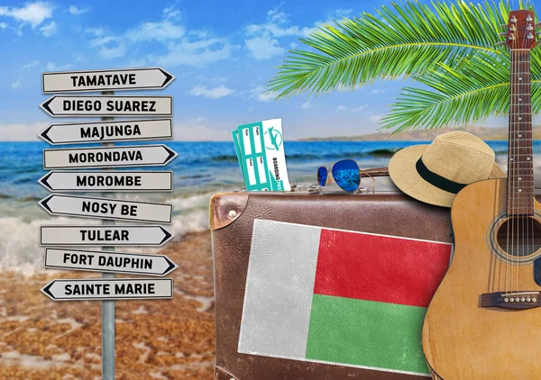 Concept of summer traveling with old suitcase and Madagascar town sign — Stock Photo, Image
