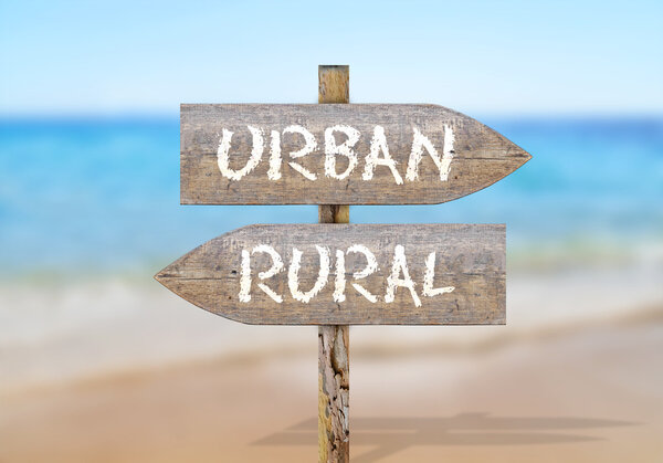 Wooden direction sign with urban and rural