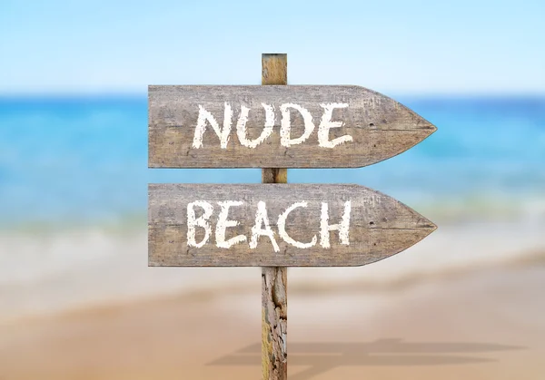 Wooden direction sign with nude beach — Stock Photo, Image