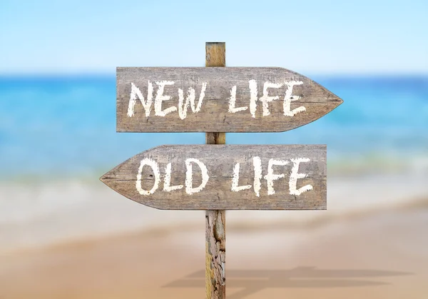 Wooden direction sign with old and new life