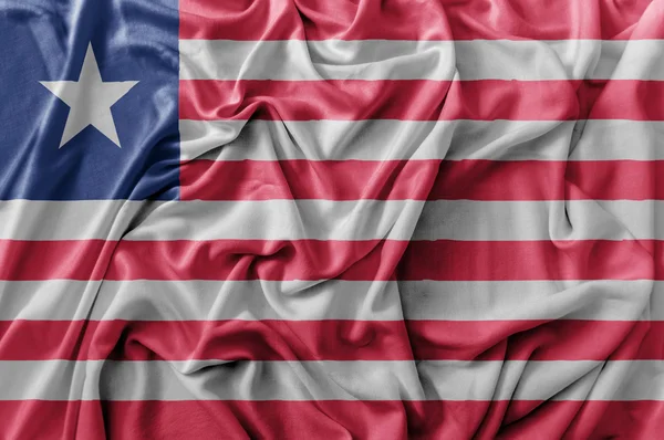 Rüpel schwenken Liberia-Flagge — Stockfoto