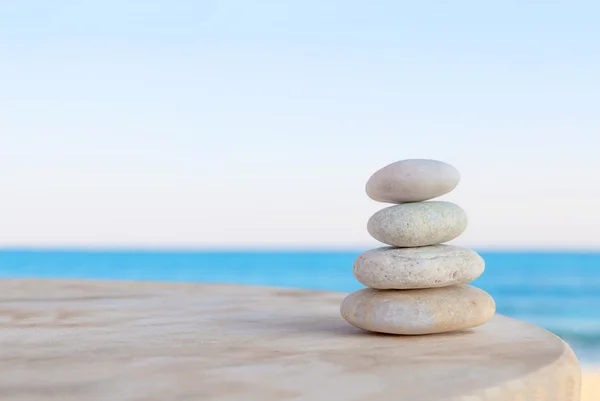 Dengeli birkaç Zen taşlar üzerinde bulanık güzel plaj arka plan