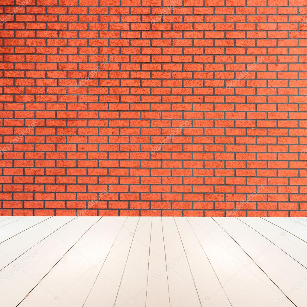 Textured red brick wall with white wooden floor inside