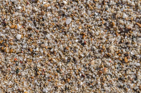 Přirozeně zaoblené písku na břehu moře, příroda beach pozadí textury — Stock fotografie