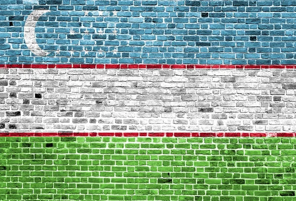 Flag of Uzbekistan painted on brick wall, background texture — Stock Photo, Image