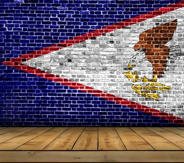 American Samoa flag painted on brick wall with wooden floor