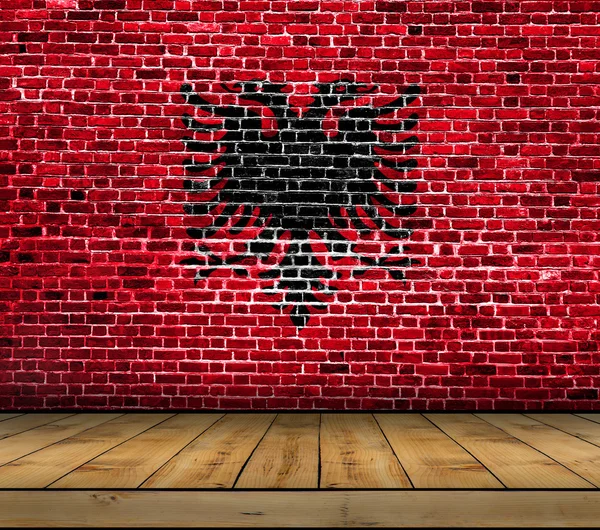 Albania flag painted on brick wall with wooden floor — Stock Photo, Image