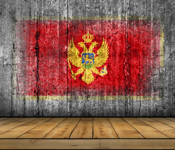 Montenegro flag painted on background texture gray concrete with wooden floor — Stock Photo, Image