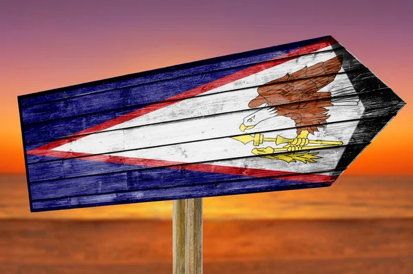 Amerikanische Samoa-Flagge Holzschild auf Strand-Hintergrund — Stockfoto