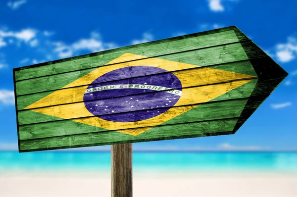 Brazil flag wooden sign with a beach background — Stock Photo, Image