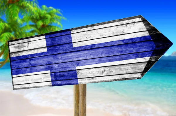 ビーチの背景にフィンランドの国旗木製サインします。 — ストック写真