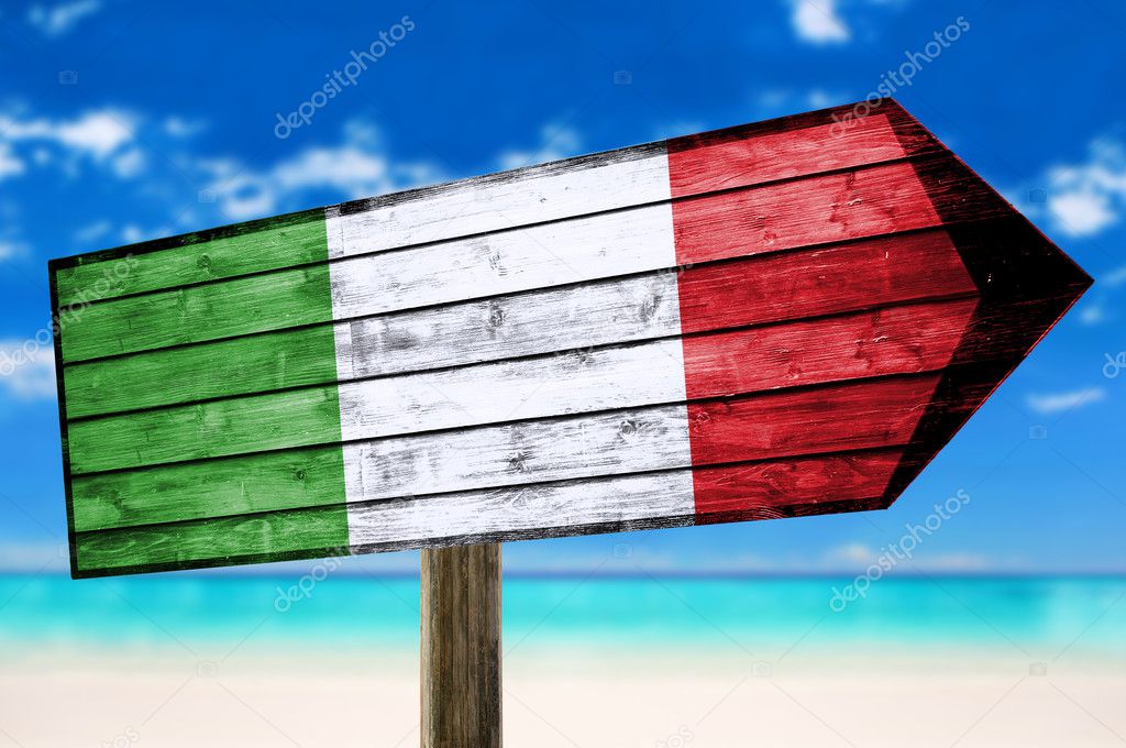 Italy on wooden table sign on beach background