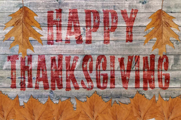 Red Happy Thanksgiving written on wooden board background with lot leaf — Stock Photo, Image