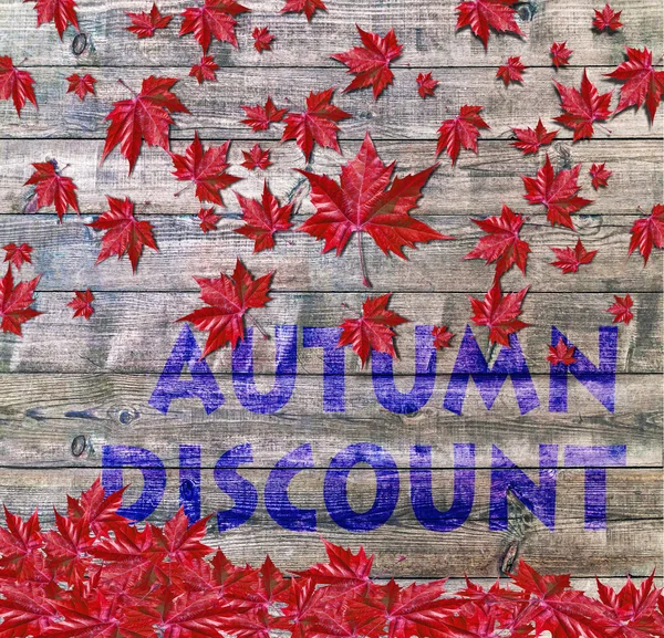 Autumn Discount and red falling leaves laying on wooden background — Stock Photo, Image