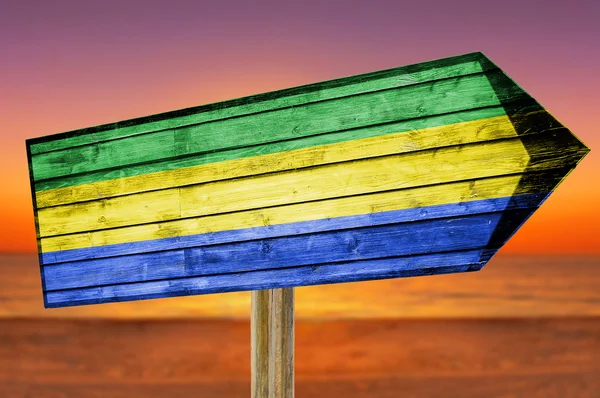 Gabon Flag wooden sign on beach background — Stock Photo, Image