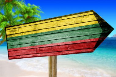 Lithuania Flag wooden sign on beach background clipart