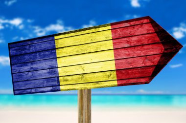 Romania Flag wooden sign on beach background clipart