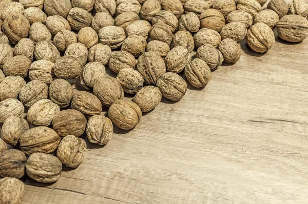 Lot of walnuts on wooden table