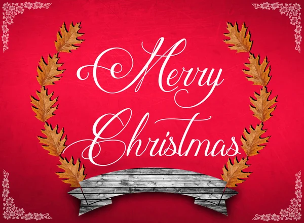 Merry Christmas and brown leaves on red background — Stock Photo, Image