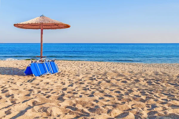 Solarium, halm paraply på vackra stranden bakgrund — Stockfoto