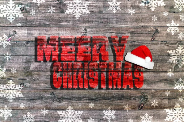 Merry Christmas written on wooden board with snowflake and Santa's hat — Stock Photo, Image