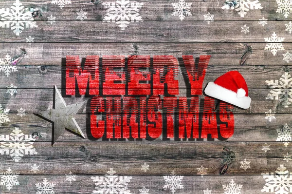 Merry Christmas written on wooden board with snowflake star and Santa's hat — Stock Photo, Image