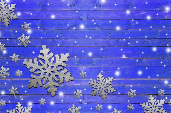 Lot of iron snowflake on weathered blue wooden board — Stock Photo, Image
