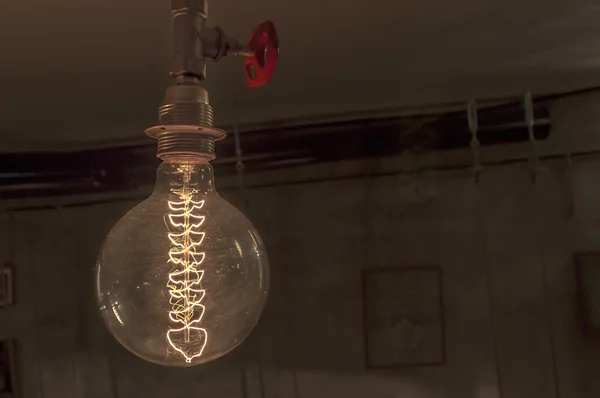 Fechar de uma lâmpada pendurada vintage iluminada — Fotografia de Stock
