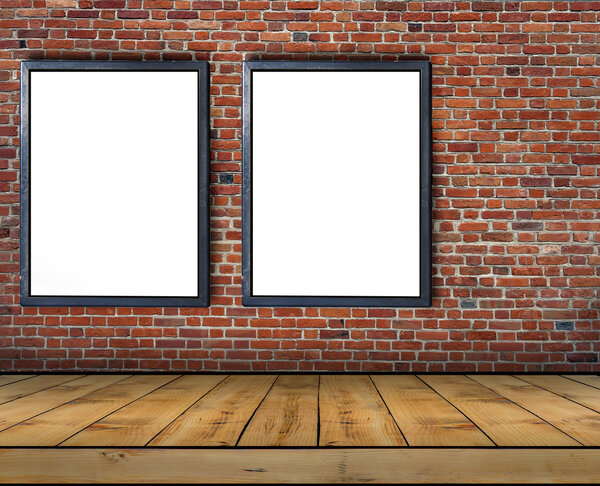 Two big blank billboard attached to a brick wall inside with wooden floor