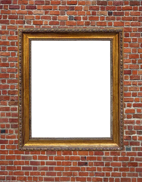 Vintage empty wooden frame hanged on brick wall