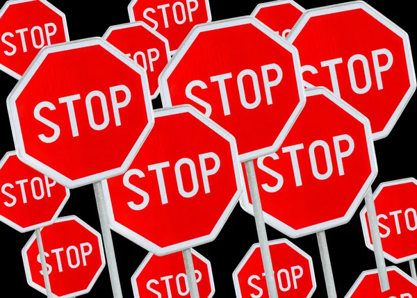 Multiple stop sign against black background — Stock Photo, Image
