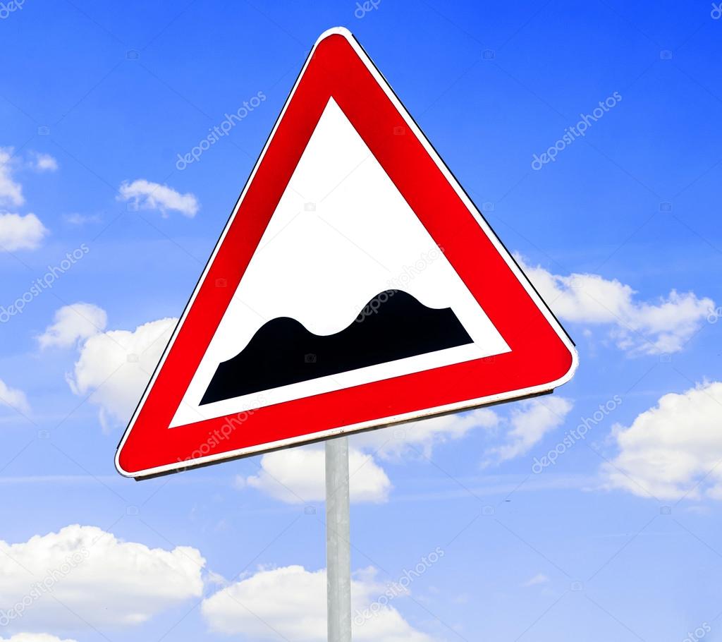 Red And White Triangular Warning Road Sign With A Warning Of A Bumpy Road Ahead Concept Against A Clear Blue Sky Background Stock Photo C Bennian
