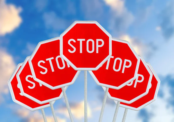 Several STOP sign on blurred cloudy sky — Stock Photo, Image