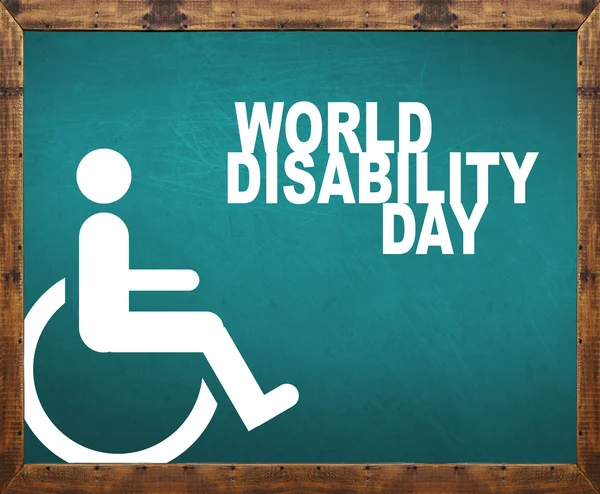 Światowy dzień osób niepełnosprawnych napisane na niebieska tablica — Zdjęcie stockowe