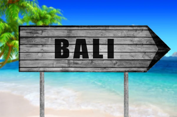 Bali wooden sign with beach background — Stock Photo, Image