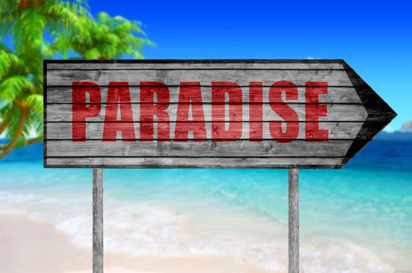 Red Paradise träskylt med på stranden bakgrund — Stockfoto