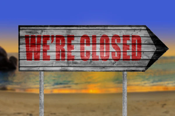 Red We 're Closed Wood sign with on a beach background — Stok Foto