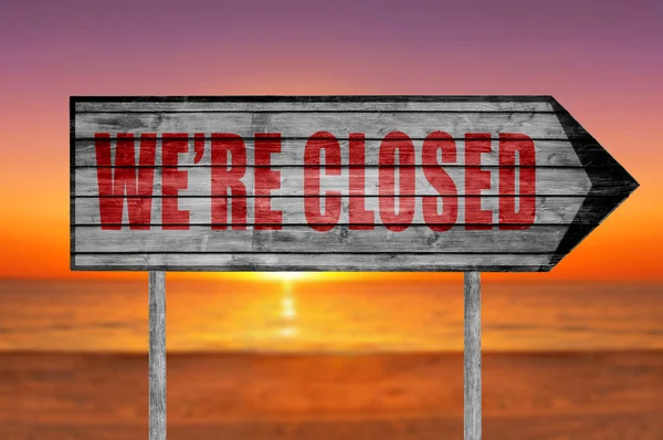 Red We 're Closed Wood sign with on a beach background — Stok Foto