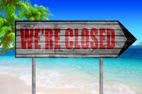 Red We 're Closed Wood sign with on a beach background — Stok Foto