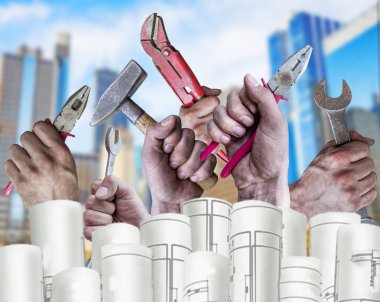 Several Hand holding tool with architect plans and city background