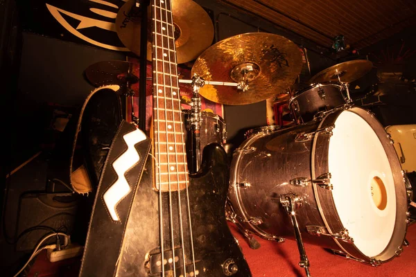 bass musical instruments and drums in a rehearsal room of a blues and rock and roll band
