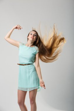Portrait of beautiful girl with perfect long shiny blond hair studio shot